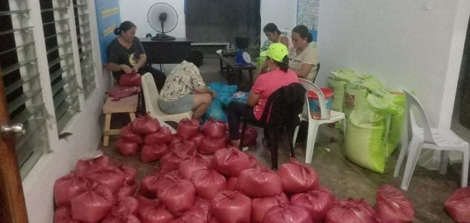 Father Donardo “Dandi” Bermejo’s coworkers at the Works of Charity Center in Manapla, the Philippines, fill bags of rice to distribute to people who were affected by a devastating super typhoon nine days before Christmas.